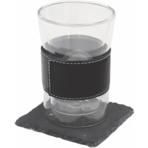 A black leather-wrapped glass sits on a square slate coaster. The set includes a coaster and a drink glass.