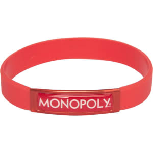 A red silicone wristband featuring a prominent branded emblem. The wristband has a smooth, flexible design.