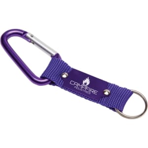 A purple keyring with a carabiner and a fabric strap featuring a logo. Ideal for attaching keys or tools.
