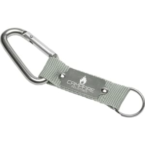 A silver carabiner keyring with a grey fabric strap and a metal plate featuring a logo.
