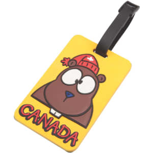 A yellow luggage tag featuring a cartoon bear wearing a red beanie, with "CANADA" displayed in bold letters.
