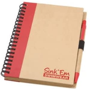 A notepad with a red and natural beige cover, featuring a black spiral binding and a red pen attached.