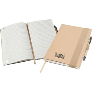 A large A5 natural notepad with lined pages, a beige cover, and an elastic band, accompanied by a pen.