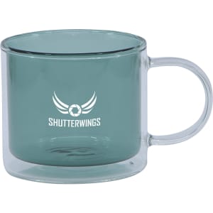 A double wall mug in a teal colour with a transparent handle, featuring a logo on one side.