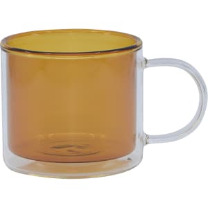 A double wall mug featuring a transparent body with an amber interior and a clear handle.