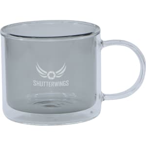 A transparent double wall mug with a grey tint and a handle, featuring a logo on the front.