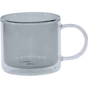 A transparent double wall mug with a light grey tint and a clear handle. The mug has a sleek design and a logo.