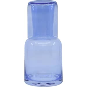 A drink bottle and tumbler set in light blue glass, featuring a sleek design and a single logo.