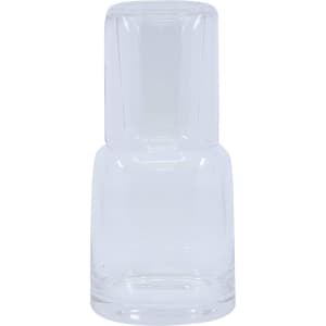 A clear glass carafe with an integrated tumbler design, featuring a simple and elegant shape.