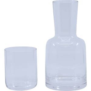 A clear glass carafe and matching tumbler set, featuring a contemporary design with smooth lines.