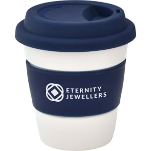 A reusable coffee cup in white and navy blue, featuring a silicone lid and a branding logo.