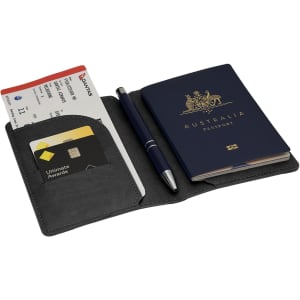 A grey passport wallet containing an Australian passport, boarding passes, a pen, and a card holder.