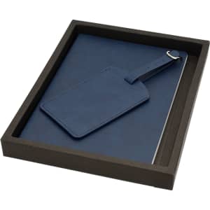 A blue travel journal set with a matching luggage tag, presented in a sleek black box.