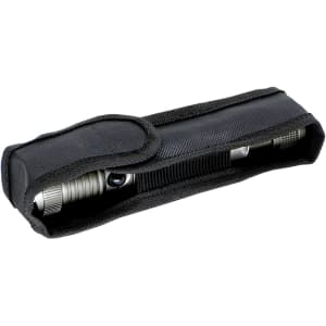 A gunmetal torch stored in a black fabric case, designed for keyrings and tools.