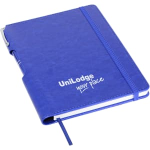 A blue A5 notebook with a pen, featuring a logo and a flexible cover.