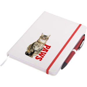 A white A5 notepad featuring a cat illustration and red text, secured with a red elastic band and accompanied by a pen.