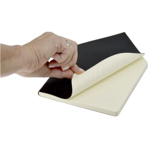A black A5 notebook with lined pages, being opened, featuring a smooth cover and a hand holding it.