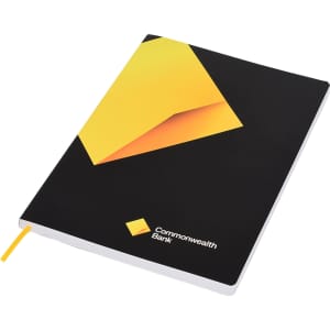 A black notebook with a geometric yellow design and a yellow ribbon bookmark, featuring a logo on the cover.