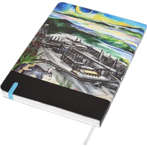 A5 notebook featuring a vibrant, multi-colour cover design, with a black band and blue ribbon marker. Includes a logo.