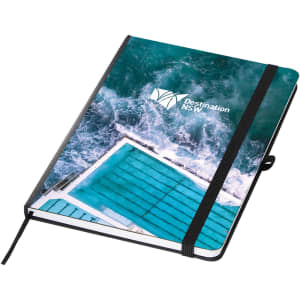 A green and blue A5 notebook with a beach pool design and a logo on the cover. It features an elastic band closure.