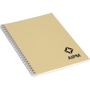 An A5 spiral-bound notebook with a beige cover and a logo on the front.