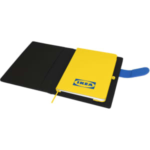 A yellow notebook with a logo inside a black portfolio, featuring a blue elastic band and bookmark.