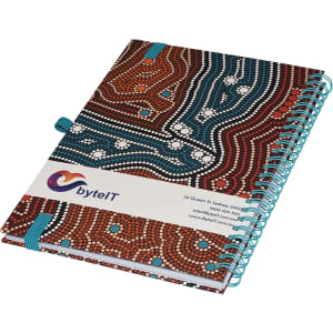 A side-bound A5 notebook featuring a colourful, patterned cover and a blue spiral binding. It includes a logo.
