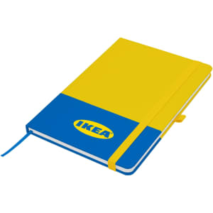 A blue and yellow A5 notebook with a logo and an elastic band closure. It features a ribbon bookmark.