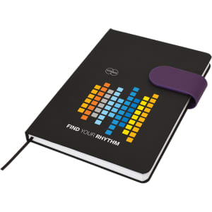 A black A5 notebook with a colourful graphic design and a purple elastic band closure. It features a logo.