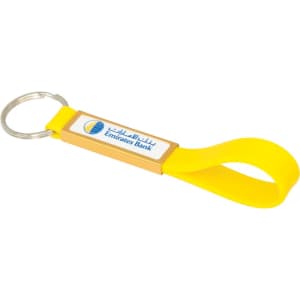 A yellow silicone sling keyring with a dome-indent and a branding logo.