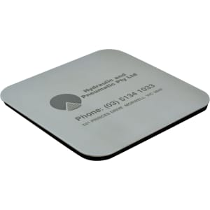 A square coaster with a silver metallic surface and a black underside, featuring a logo and contact information.