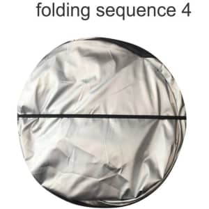 A round, silver sunshade with a black trim, depicting the fourth folding sequence.