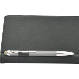 A black A5 notebook with a silver pen resting on top, featuring a smooth texture and a logo on the cover.