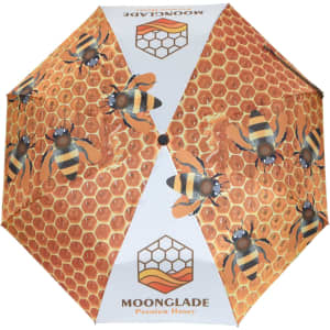 A full-colour umbrella featuring a honeycomb design with bees. Includes a logo and a vibrant colour palette.