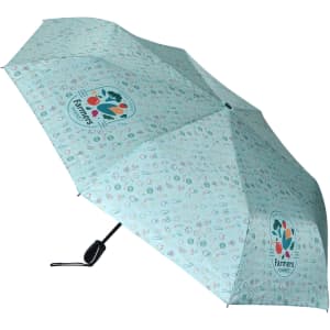 A mint green umbrella with a playful pattern and a logo. Features a manual opening mechanism.