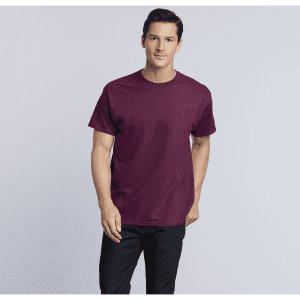 A maroon heavy cotton adult T-shirt displayed on a male model, featuring a simple design and a logo.