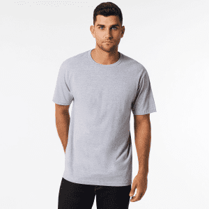A grey Softstyle Adult Midweight T-Shirt with short sleeves, displayed on a model. The shirt features a logo.