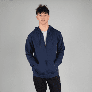 A navy zip hoodie featuring a front pocket and a hood, modelled by a person with hands in pockets.