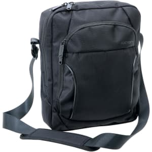 A black Exton vertical satchel with a shoulder strap and multiple zippered pockets. It features a logo.