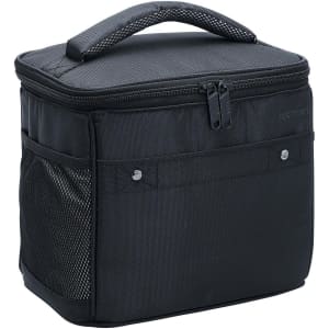 A black Exton cooler bag with a zip closure and handle, featuring a front mesh pocket and branding.