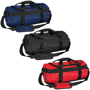A small waterproof gear bag in navy, black, and red, featuring handles and a shoulder strap. It has a logo.
