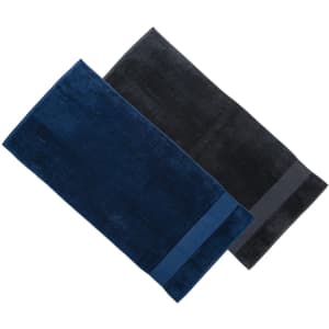 Two plush bath towels in navy blue and black, featuring a branding logo.