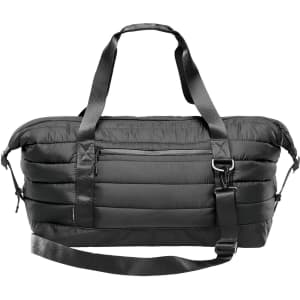 A black quilted duffle bag featuring dual handles and a removable shoulder strap, with a zippered front pocket.