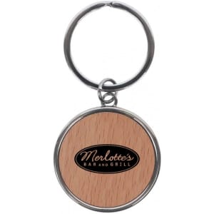 A round keychain featuring a wooden design and a logo on the front, attached to a metal ring.