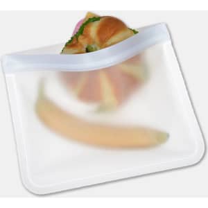 A transparent, reusable PEVA food storage bag containing a sandwich and a banana. Features a zip closure and a logo.