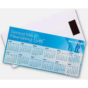 A blue magnetic calendar features monthly grids and is placed over a white envelope, showcasing a logo.