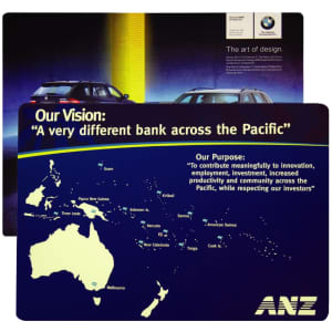 A counter mat featuring a blue background with a map of the Pacific and vehicle images. It includes a logo.