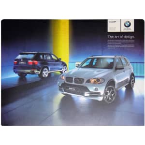 A counter mat featuring two BMW vehicles in a gradient backdrop, highlighting a modern design with vibrant blue and yellow colours.