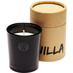 A black glass candle with a white wick, presented in a cylindrical brown cardboard box.