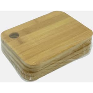 A bamboo cutting board in a stack, featuring a rounded edge and a hole for hanging. Wrapped in plastic.